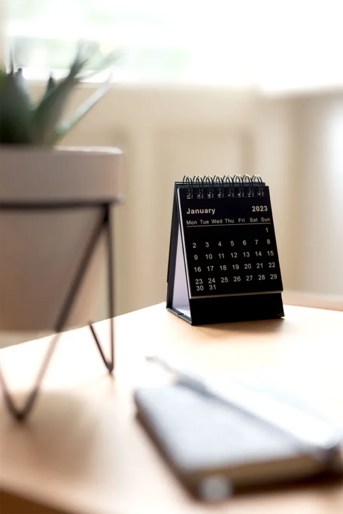 Desk calendar on a workspace, illustrative stock photo