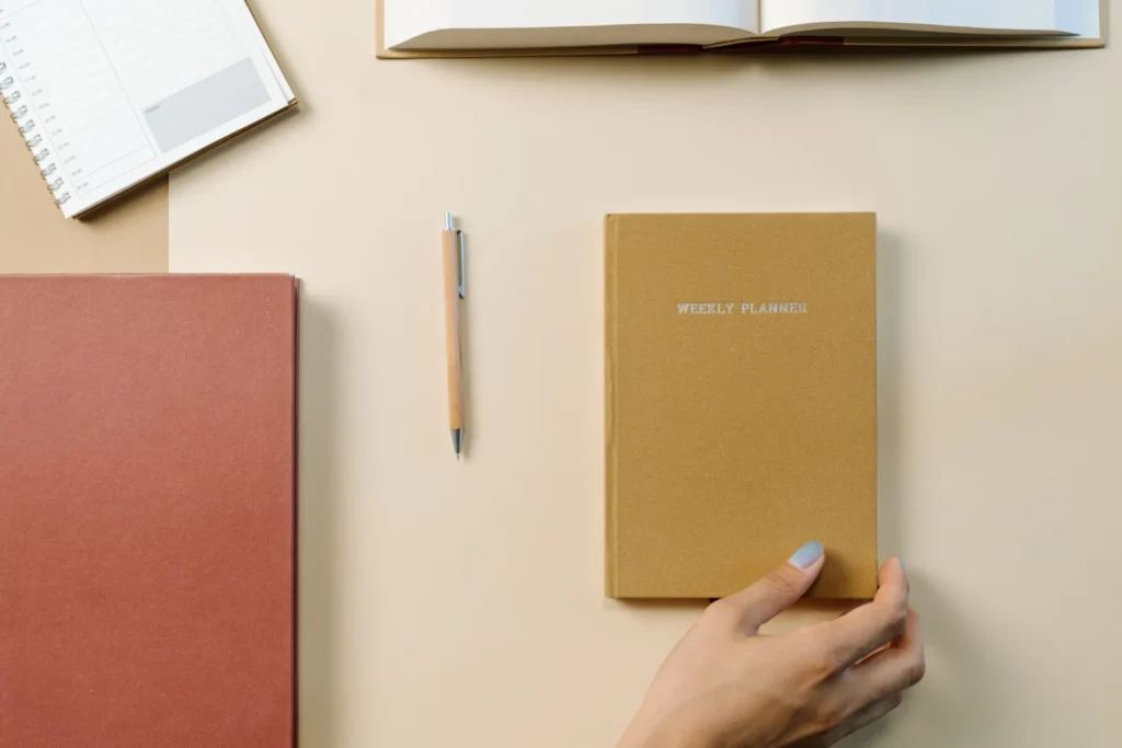 Notebooks and planner on a desk, illustrative stock photo