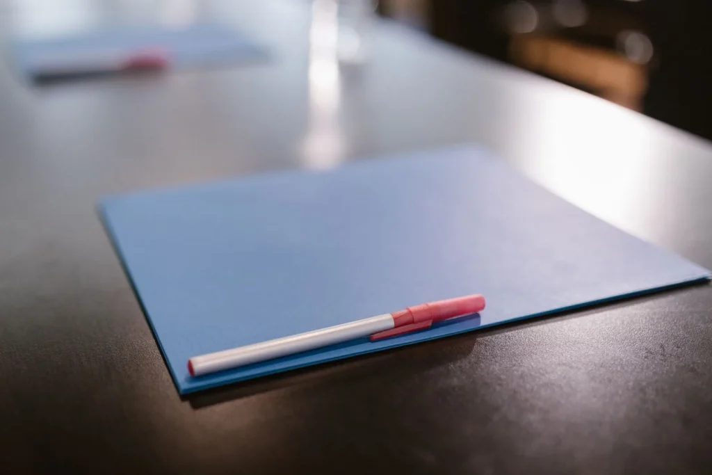 Blue presentation folder with a pen on an office table